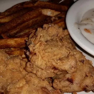 Steak fingers with fries and gravy.