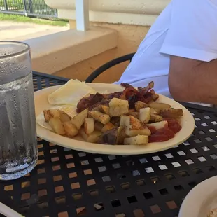 Two egg breakfast with crispy bacon and home fries