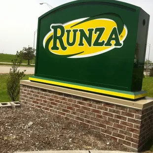 a green sign with yellow letters