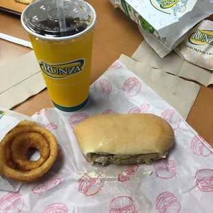 a sandwich and onion rings on a table