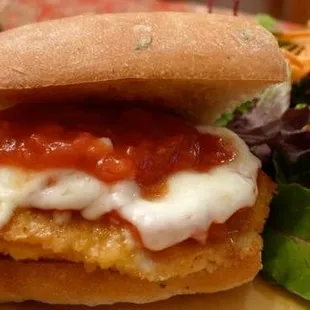 a chicken sandwich and a salad