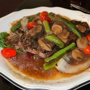 Pepper Steak. Peppercorn NY strip with onion, green pepper, mushroom, tomato. The burgundy wine sauce is incredible.