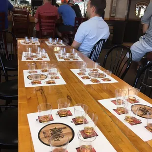 a long wooden table with glasses of wine on it
