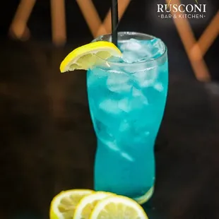 a blue drink with a lemon slice