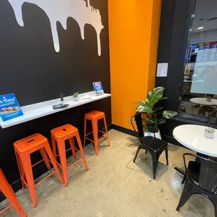 a table with four orange stools