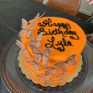 a birthday cake decorated with butterflies