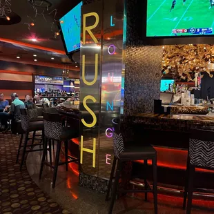 a view of the bar and televisions