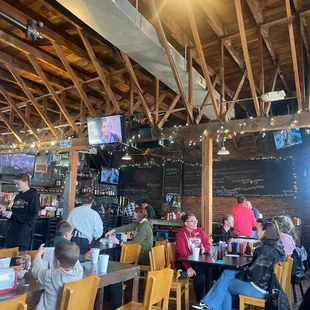 people sitting at tables in a restaurant