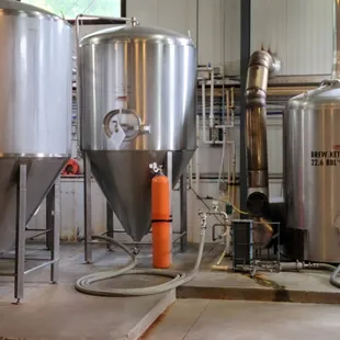 a row of stainless steel tanks