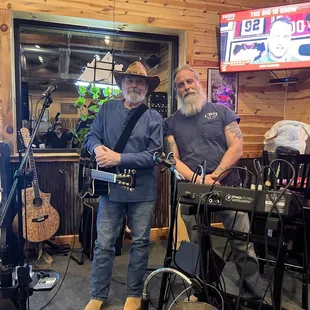two men playing guitars