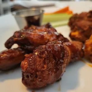 Half sweet-chili, half buffalo flavored chicken wings appetizer.