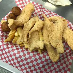 a basket of fried fish and fries