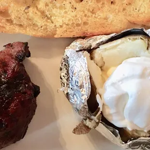 Filet, baked potato, and garlic bread