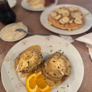 Eggs Lafitte- eggplant rounds, fried green tomatoes, poached eggs topped with Monica sauce &amp; lump crab meat &amp; peanut butter banana waffles