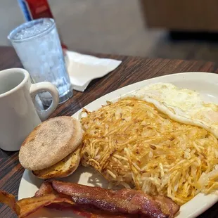 Russell's breakfast, two eggs over easy hash browns with cream cheese and other cheeses and black label bacon.