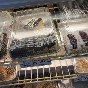 a variety of pastries in a display case