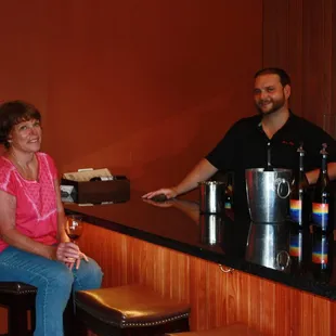 a man and a woman sitting at a bar