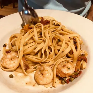 Shrimp scampi over fettuccine was beautifully presented too, but someone already stirred it and took a bite.