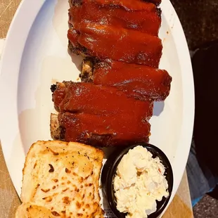 1/2 rack of ribs with potato salad and garlic bread