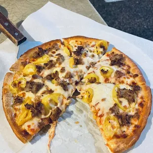 Small pizza with hot peppers and sausage