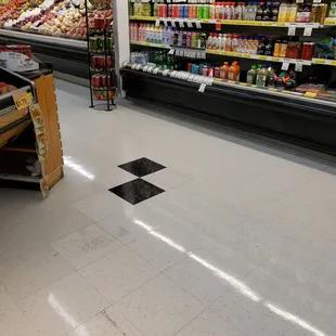 a grocery aisle with a checkered floor