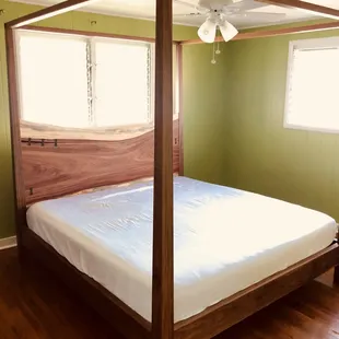 Walnut canopy bed with live edge headboard