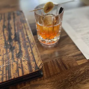 a drink in a glass on a wooden table