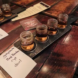 a row of glasses of whiskey