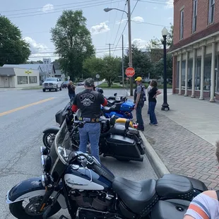 a group of motorcycles parked on the side of the road