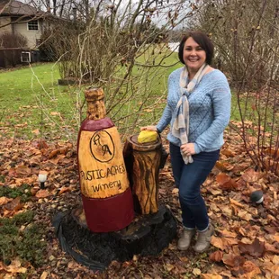 a woman standing next to a bottle of brandy