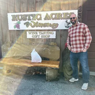 a man standing in front of a sign