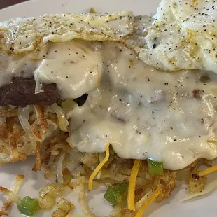 a plate of food with hash browns and eggs