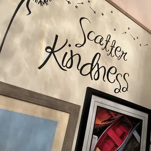 a picture of a wall with a picture of a boat and a dandelion