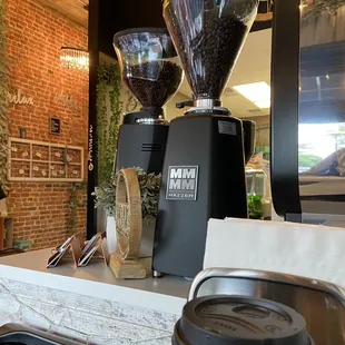 two coffee grinders on a counter