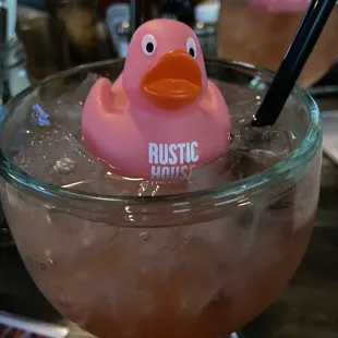 a pink rubber duck in a glass