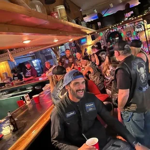 a group of people sitting at a bar