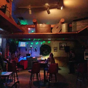 people sitting at tables in a dimly lit room