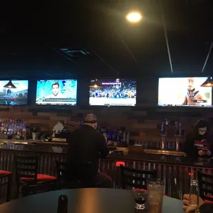 View of the bar. 8 TVs total with above the bar.