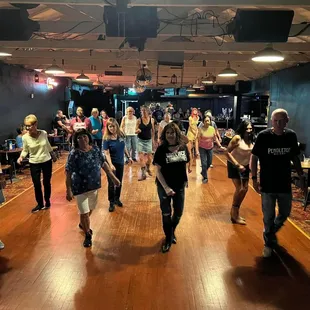 a group of people dancing in a dance studio