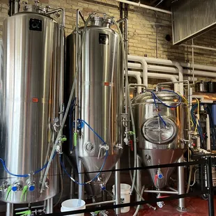 a row of stainless steel tanks