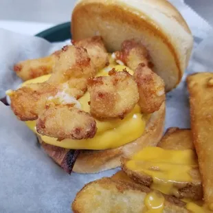 WI Burger- Hand pattied burger topped with bacon, and WI cheese curds. Severed with seasoned potato wedges smothered in cheese sauce!