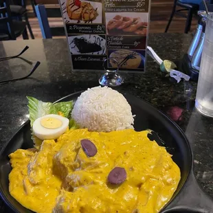 Aji de Gallina - shredded chicken in a yellow Peruvian sauce with white rice