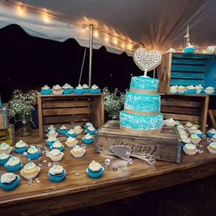 Our Custom Wood Table Tops fit nicely on 2 of our Whiskey Barrels.  Paired with several wooden crates to make this dessert table.