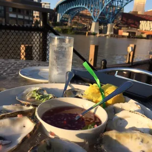 a plate of oysters and a glass of water