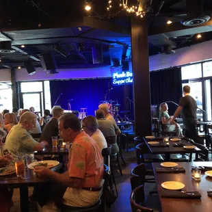 a group of people sitting at tables in a restaurant