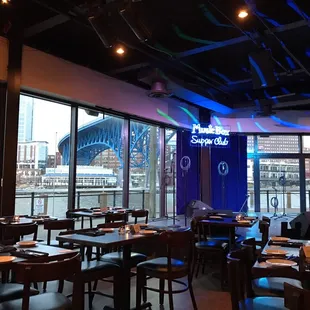 the interior of a restaurant with tables and chairs