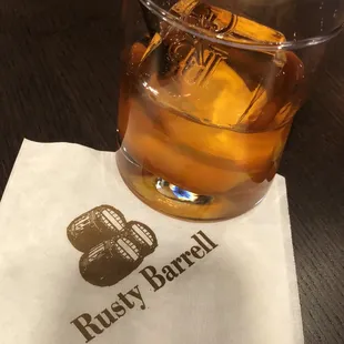 a glass of whiskey on a napkin