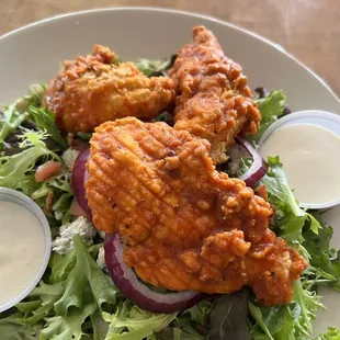 Buffalo chicken salad. So good! Chicken tossed in medium sauce, salad greens, tomatoes, red onion, &amp; blue cheese crumbles.
