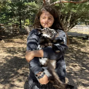 Snuggles w 1 month old goat