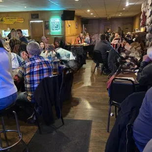 people sitting at tables in a restaurant